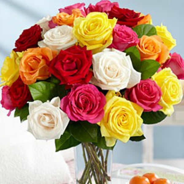 Bouquet of multicolored roses in a clear glass vase