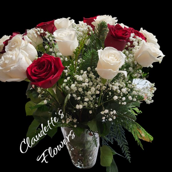 Bouquet of red and white roses in a clear glass vase