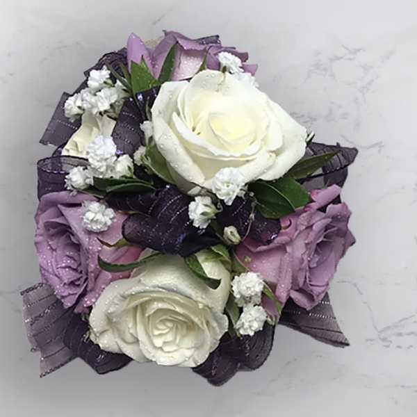 Bouquet of white and lavender roses with dark ribbon accents
