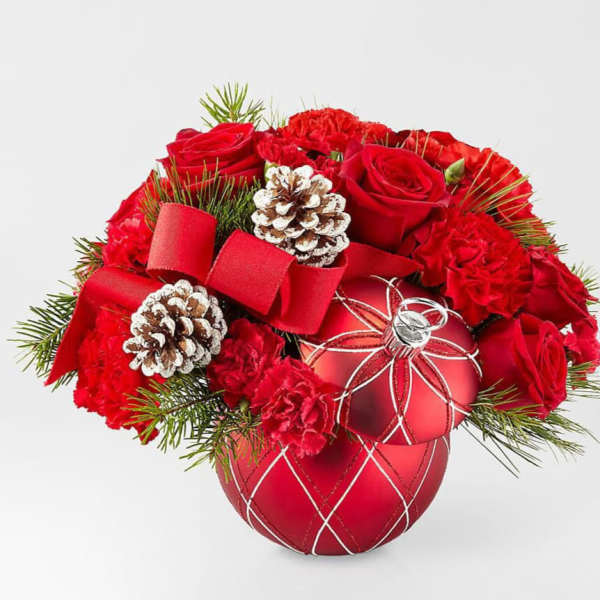 Red roses and carnations arranged with pinecones in a red ornament vase