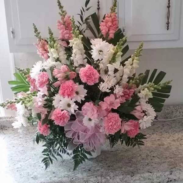 Pink and white floral arrangement with daisies and carnations