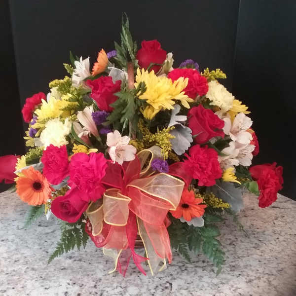 Mixed bouquet of roses, carnations, and daisies with a ribbon