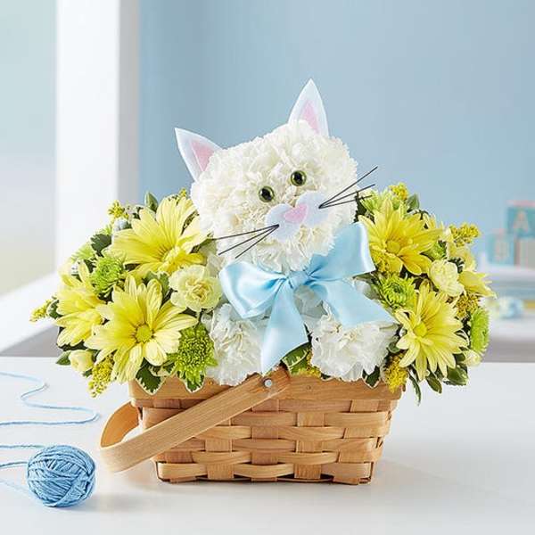 Cat-shaped flower basket with yellow and white blooms and a blue bow