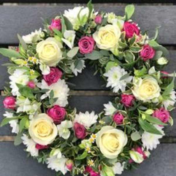 Floral wreath with cream and pink roses and white daisies