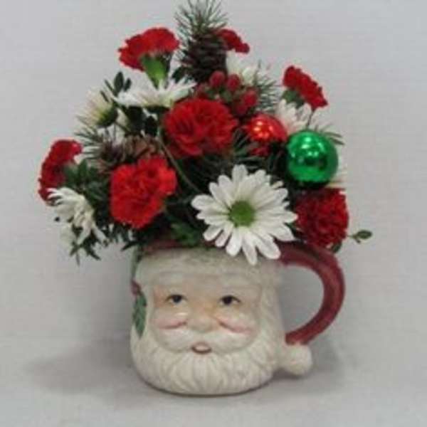 Santa mug filled with red and white flowers and holiday ornaments