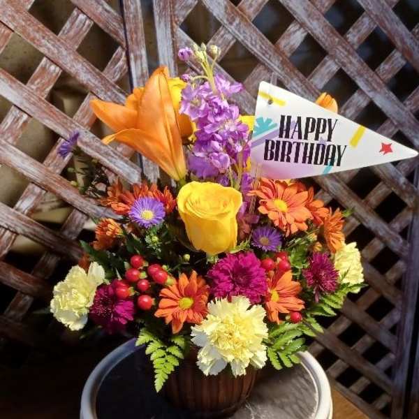 Colorful mixed bouquet in a vase with a Happy Birthday sign