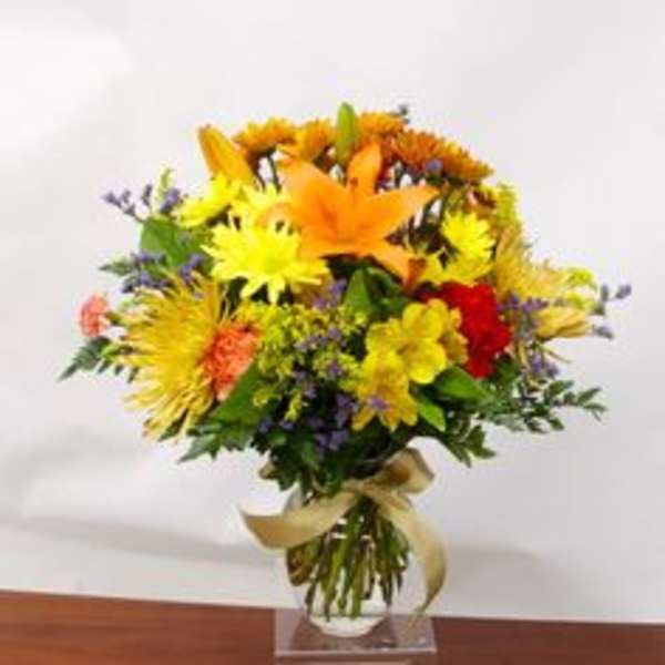 Colorful bouquet of mixed flowers in a clear vase