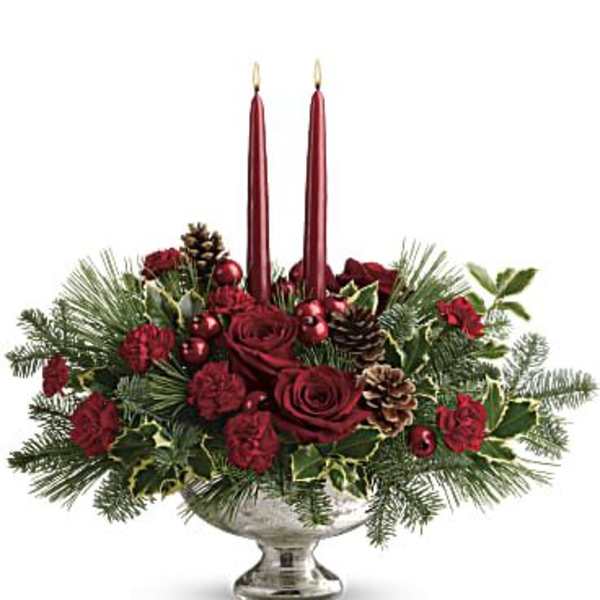 Red rose centerpiece with two tall candles in a silver bowl