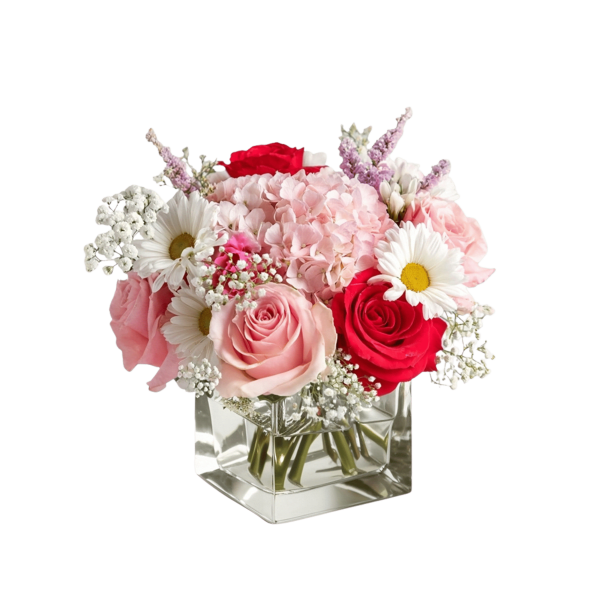 Pink and red roses with white daisies in a clear square vase