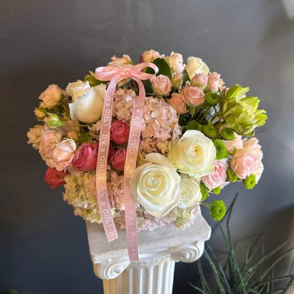 Pink and white rose bouquet with hydrangeas and a pink ribbon