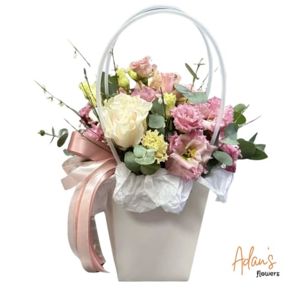 Pink and white bouquet in a white handled box with ribbon