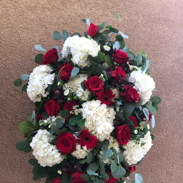 Standing floral spray with red roses and white hydrangeas
