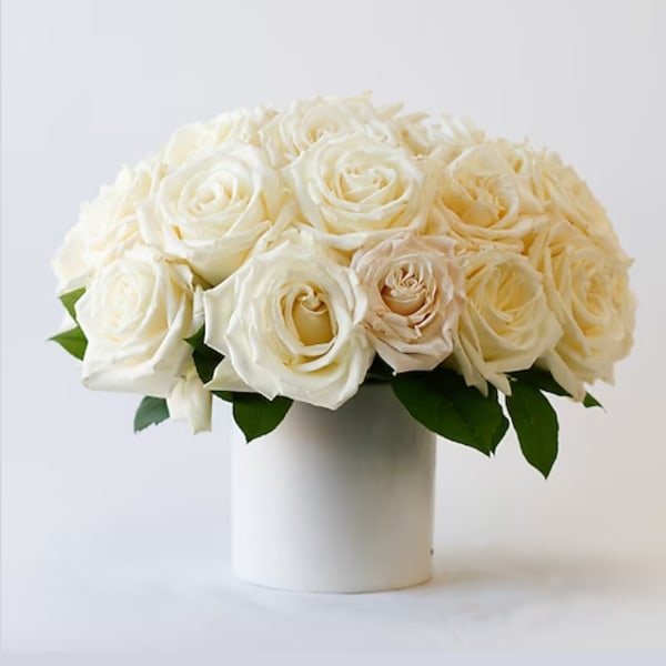White rose bouquet in a white cylindrical vase