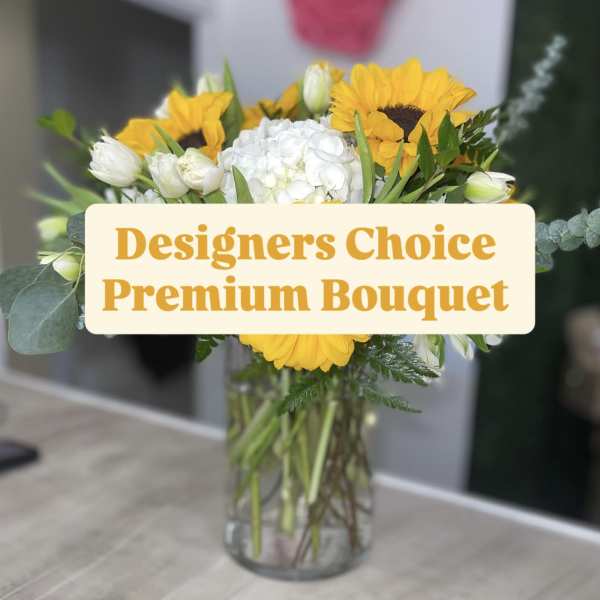 Bouquet of yellow sunflowers and white flowers in a glass vase