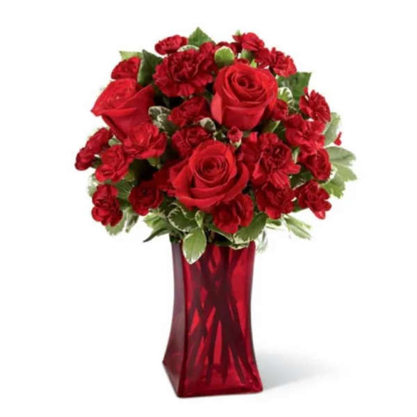 Red roses and carnations in a red glass vase