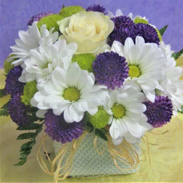 Bouquet of white daisies, purple blooms, and a pale yellow rose