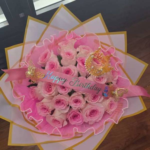 Pink rose bouquet with a Happy Birthday ribbon and decorative wrapping