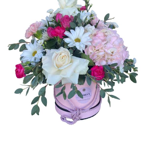 Pink and white mixed flower arrangement in a lavender hat box