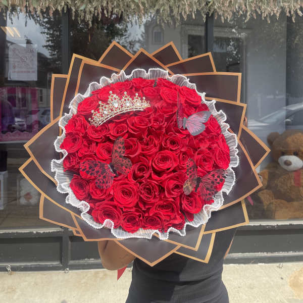 Large bouquet of red roses with a tiara and butterfly decorations