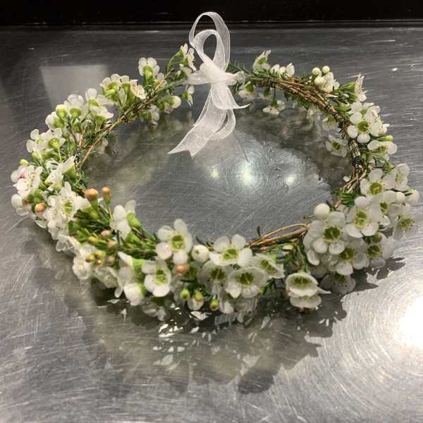 White floral wreath with a sheer ribbon bow