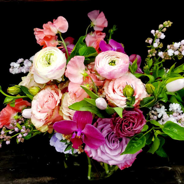 Mixed pink and purple bouquet with roses and ranunculus