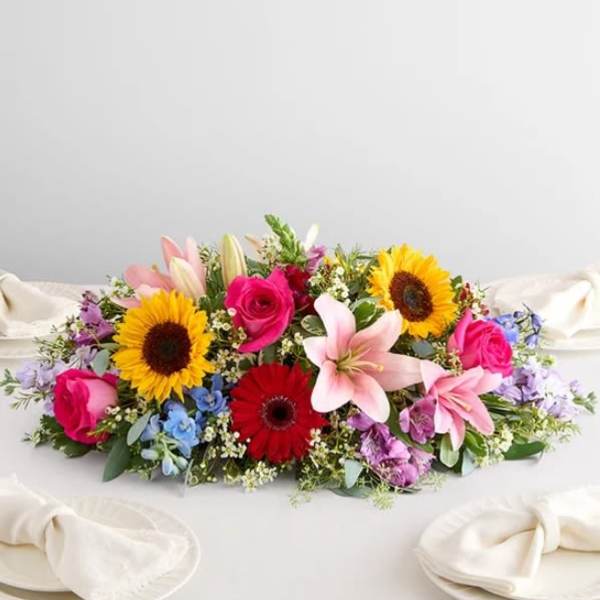Colorful bouquet with sunflowers, roses, lilies, and gerbera daisies