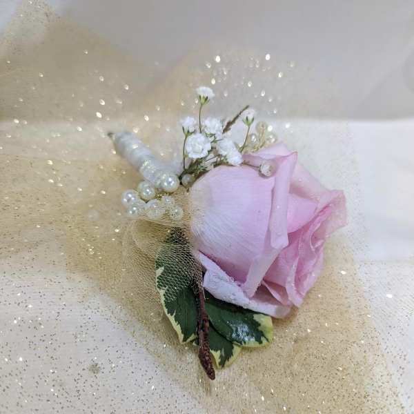 Pink rose boutonniere with pearl accents and gold tulle wrap