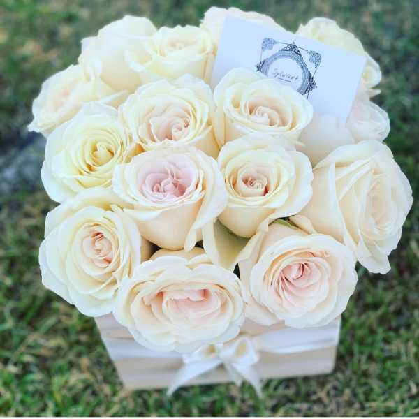 Bouquet of cream and blush roses in a white box with a ribbon