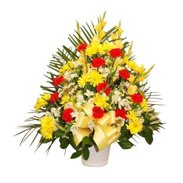 Yellow and red floral arrangement in a white vase with a ribbon