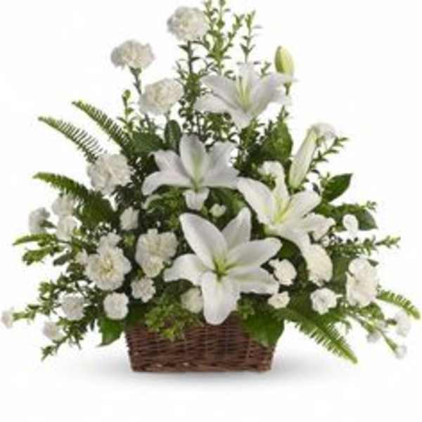 White lilies and carnations in a wicker basket