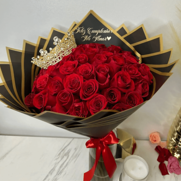 Bouquet of red roses with a jeweled crown and black-and-gold wrapping