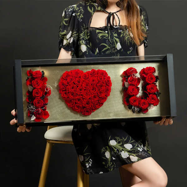 Framed red rose arrangement spelling "I LOVE U"