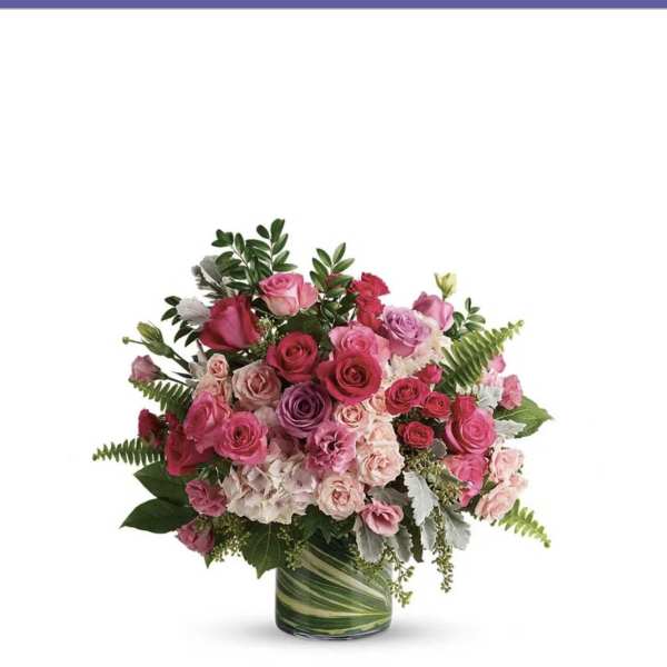 Pink and purple rose bouquet in a glass vase