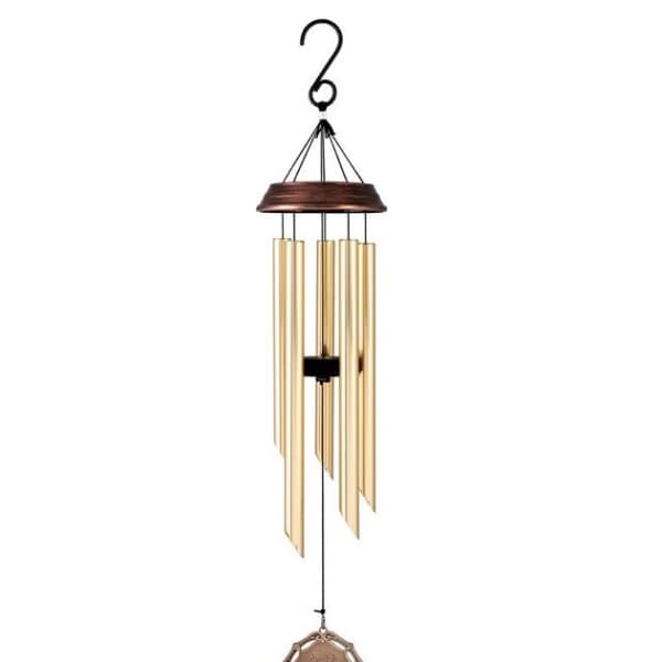 Hanging metal wind chime with gold tubes and a decorative medallion