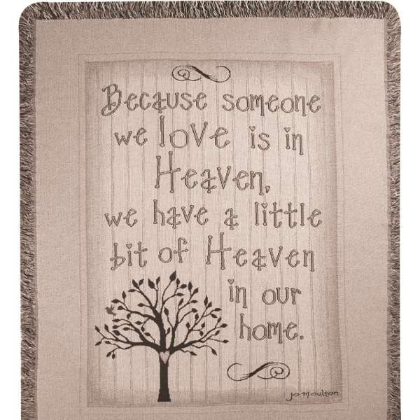 Fringed wall hanging with a quote and tree graphic