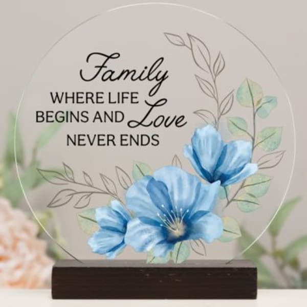 Decorative plaque with blue flowers and the words "Family where life begins and love never ends"
