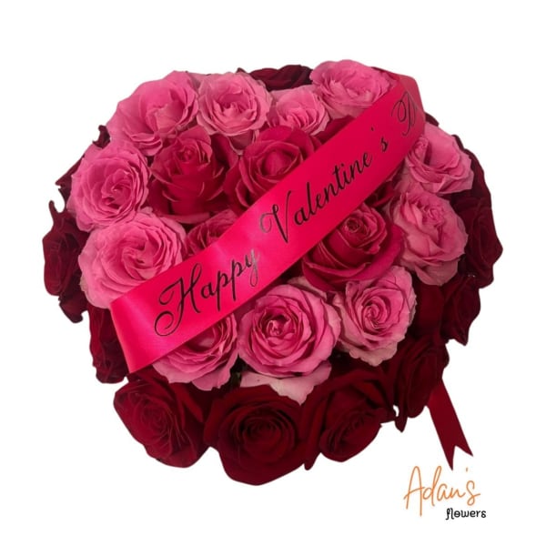 Bouquet of pink and red roses with a Valentine ribbon