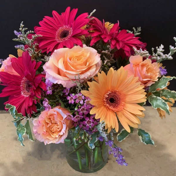 Bouquet of pink and peach flowers in a glass vase