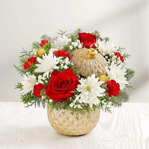 Red roses and white daisies arranged in a gold ornament-shaped vase