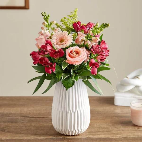 Pink and red mixed bouquet in a white vase