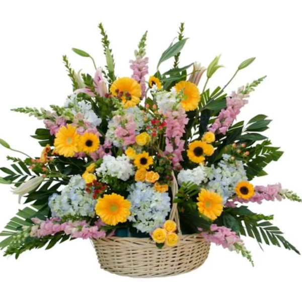 Basket arrangement of yellow, pink, and white flowers