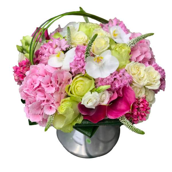Pink and white floral arrangement in a round silver vase