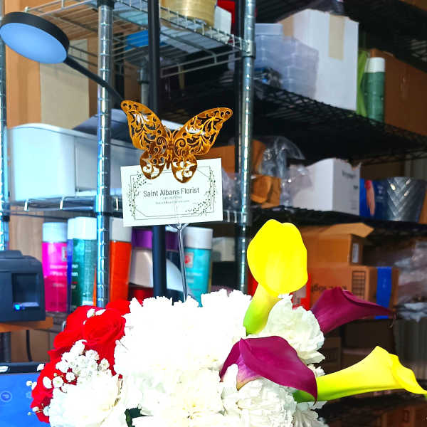 Flower gift box with white and red blooms and a box of chocolates