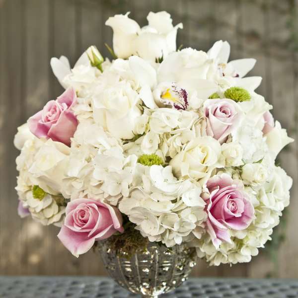 Pink and white rose bouquet in a silver vase