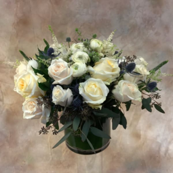 White rose bouquet in a dark green vase