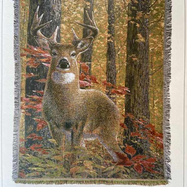 Fringed wall hanging with a deer in an autumn forest scene