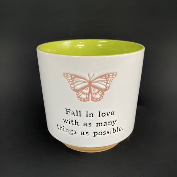 White ceramic cup with a butterfly and quote