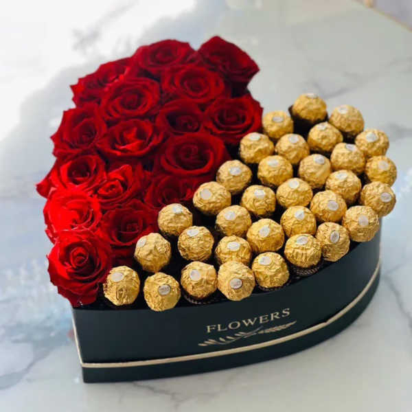 Heart-shaped box of red roses and gold-wrapped chocolates