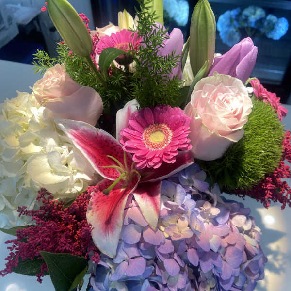 Bouquet of pink lilies, roses, hydrangea, and a gerbera daisy