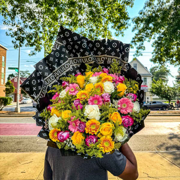 Large bouquet of mixed roses, gerbera daisies, and yellow filler flowers